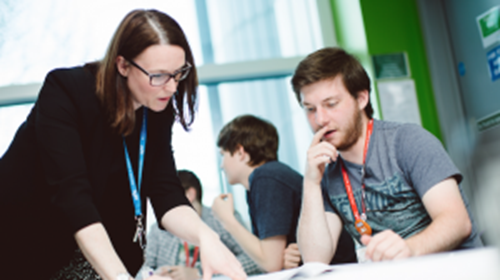 Teacher discussing work with a student