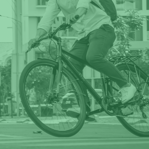 Person riding a bicycle to work with green tint