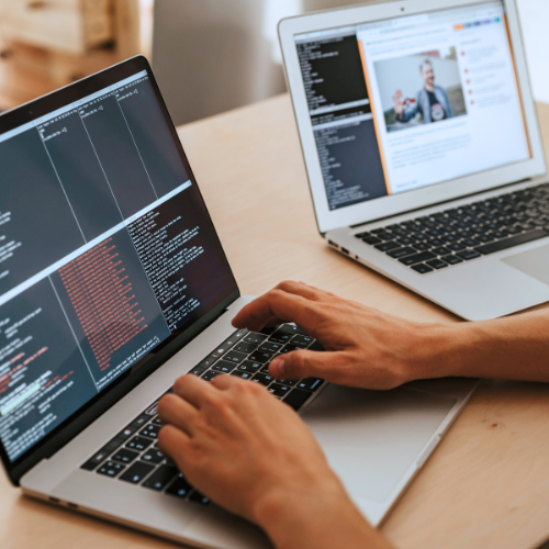Close up of person coding on a laptop.