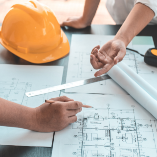 Close up of people discussing building plans.