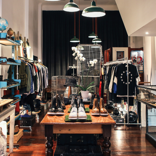 Shop with clothes and shoes on display.