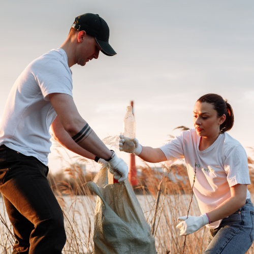Two people collecting litter.